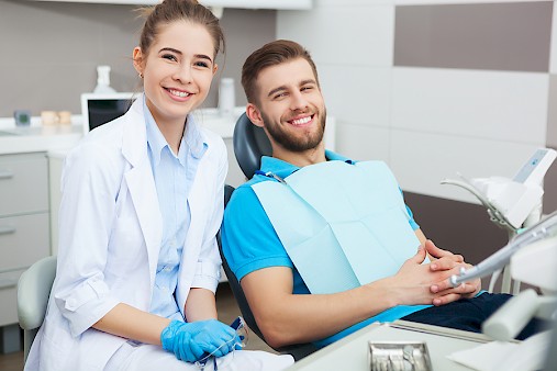 Portrait Of A Female Dentist And Young Man In A Dentist Office.
